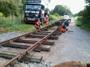 Personnel start to take the unloading ramp apart