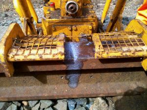 Newly drilled holes in a rail, ready for the installation of track circuit bond wires.