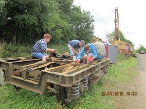 The first cleaned up B5 bogie is repainted using black chlorinated rubber paint, by Nationwide Building Society volunteers on 29th July 2015. Photo: Grahame Every
