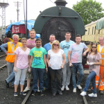 Nationwide Building Society staff and N&LR Volunteer Working Members Grahame Every and David Millard stand in front of Peckett 2105 on 15th July 2015