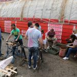 Nationwide Building Society volunteers are seen wire brushing track nuts and bolts, with others using threading taps to clean the threads of some track nuts.