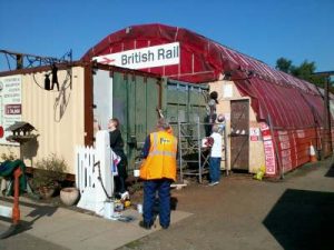 Volunteer Coordinator Grahame Every and Nationwide Building Society volunteers, Carol, Lis, Peta and John start to paint the container ends with BS381C Biscuit and Mid brown. Photo: D.Millard