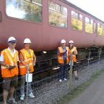 Nationwide Building Society volunteers, Rob, Helen, Vicky and Paul stand in front of BR Mk2 coach 5174 and its repainted B4 bogies. Photo: D.Millard