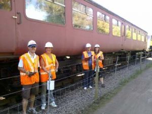 Nationwide Building Society volunteers, Rob, Helen, Vicky and Paul stand in front of BR Mk2 coach 5174 and its repainted B4 bogies. Photo: D.Millard