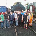 Nationwide Building Society volunteers stand in front of the Peckett steam locomotive, with Facilitator David Millard in orange Hi-Viz. Photo: G.Titmuss