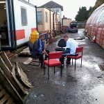 Nationwide Building Society volunteers sit outside (once the rain had stopped) brushing the rust off some track (fishplate) bolts. Photo: David Millard