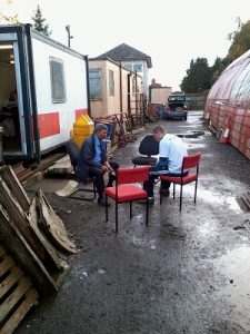 Nationwide Building Society volunteers sit outside (once the rain had stopped) brushing the rust off some track (fishplate) bolts. Photo: David Millard