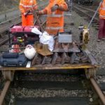 Next step. Chris and James Coulson have just pushed the trolley along the line from Pitsford & Brampton with half a ton of tools, generator, and new check rail chairs to accept the left and right hand splayed ends of the new check rails we’ve just made. Time for the team to get to work. Photo: Graham Peacock