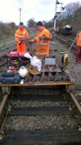 Next step. Chris and James Coulson have just pushed the trolley along the line from Pitsford & Brampton with half a ton of tools, generator, and new check rail chairs to accept the left and right hand splayed ends of the new check rails we’ve just made. Time for the team to get to work. Photo: Graham Peacock
