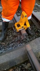 The attachment clamped to rail hold the disc cutter and helps guide it to cut the rail safely and obtain a decent straight cut. It was raining when we did this job and the rail is obviously wet, apart from where the heat from the cutting operation has dried out the end section. Photo: Graham Peacock