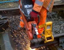 Then we trimmed the opposite ends of the rail, eliminating any ends that were flame cut when London Underground removed the rail from the District Line and producing a final length of 13 feet. Note the use of the guide which the disc cutter is now attached to. The rail has been placed in chairs to keep it off the ground and secure from any inadvertent movement whilst we cut it. Photo: Graham Peacock