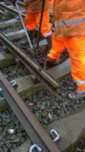 The straight rail is placed with the head in the crow. A piece of point rodding has been placed on top to use as a straight edge to measure the offset of the bend. Now comes the hard bit. It has to be physically wound around to bend the rail. Rail is flexible to a degree, and doesn’t come in curves for the track, as for the normal curvature on a running line, will easily flex to the curve being laid. But producing a physical bend over a short distance is hard work, and requires effort. Photo: Graham Peacock